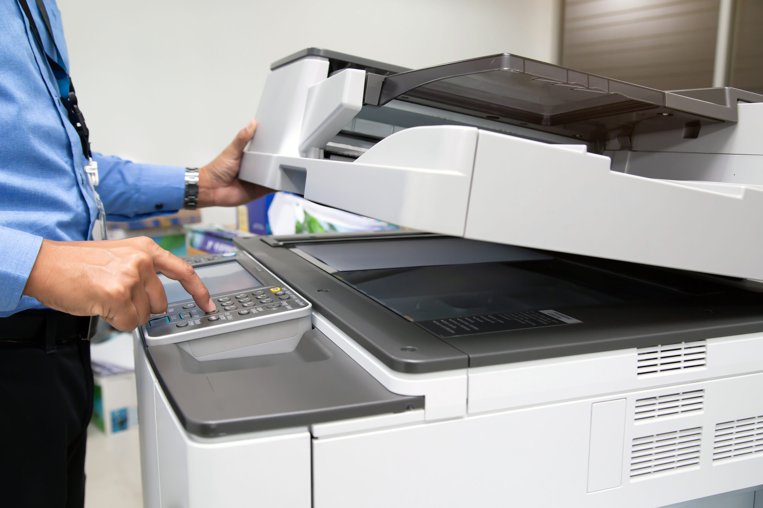 closeup hand press button using photocopier scaled
